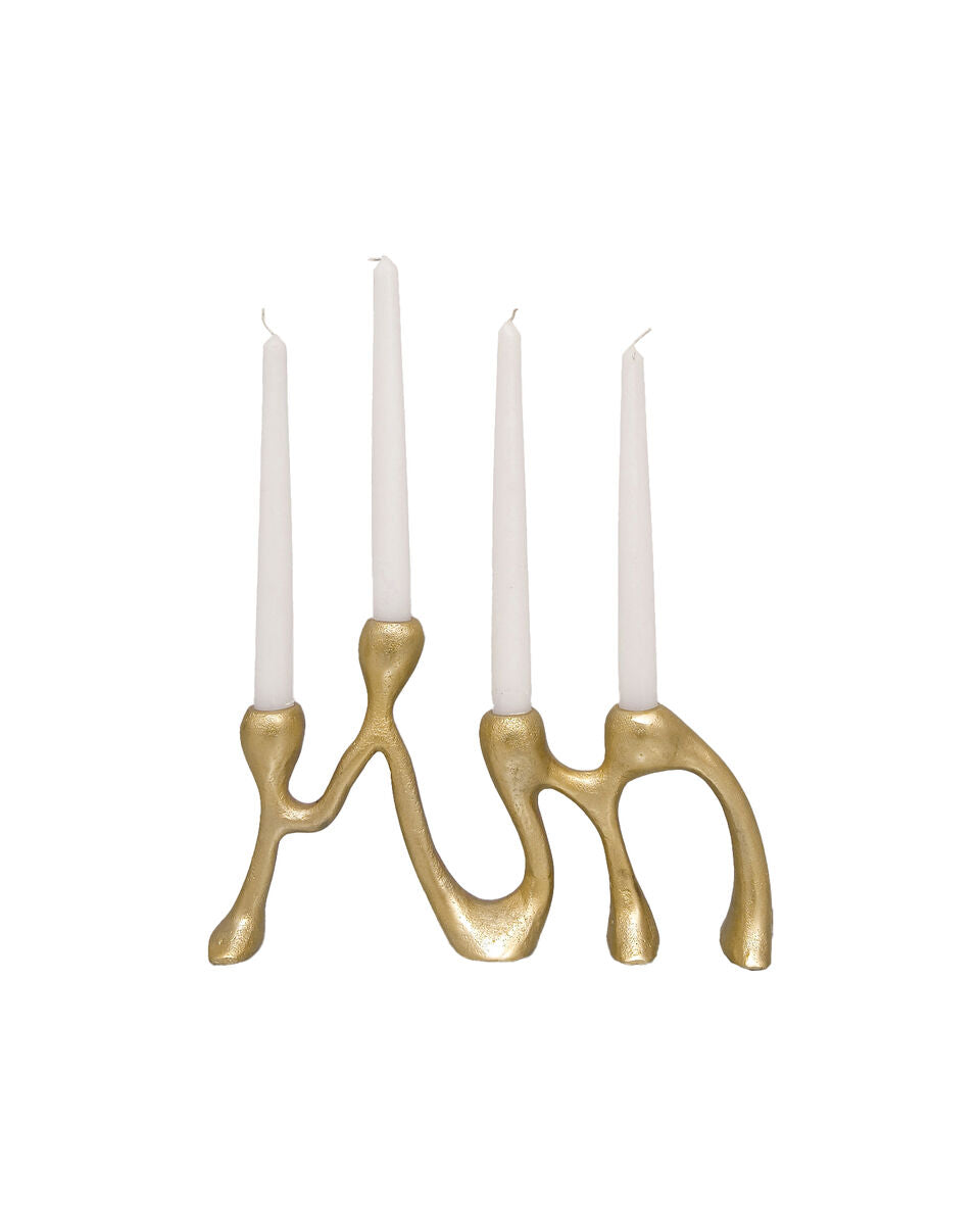 Gold candle holder with four white candles on a white background