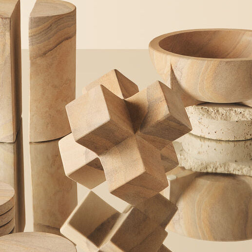 Wooden geometric shapes on a beige surface with a neutral background