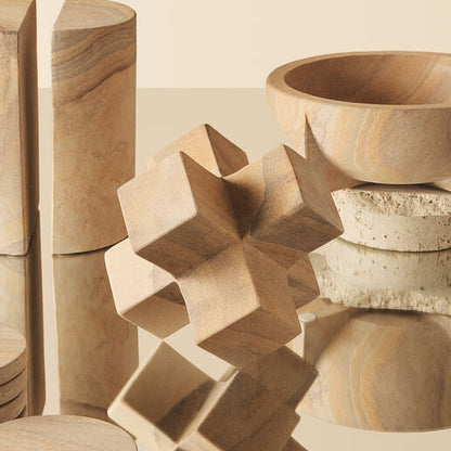 Wooden geometric shapes on a beige surface with a neutral background