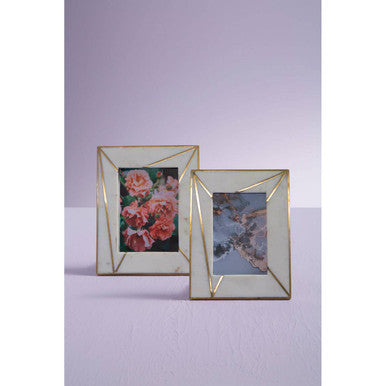 Two gold geometric photo frames on a light purple background