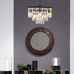 Modern interior design with a console table, mirror, and decorative items against a gray wall.