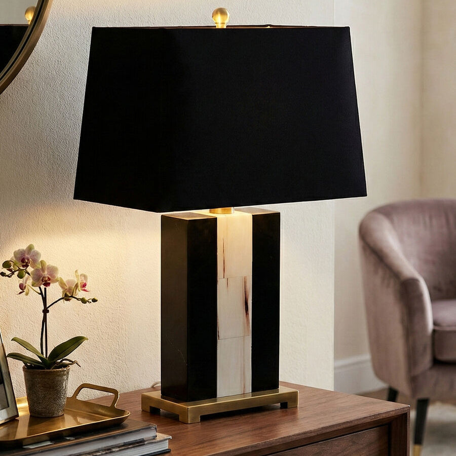 Black table lamp on a wooden surface with a blurred background