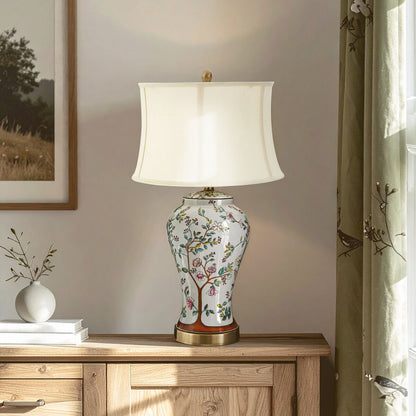 Decorative table lamp with floral design on a wooden cabinet