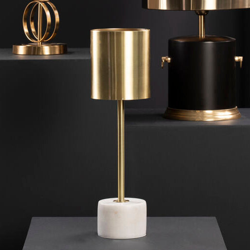 Three table lamps with gold and black designs on a dark background