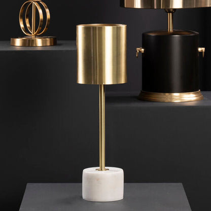 Three table lamps with gold and black designs on a dark background