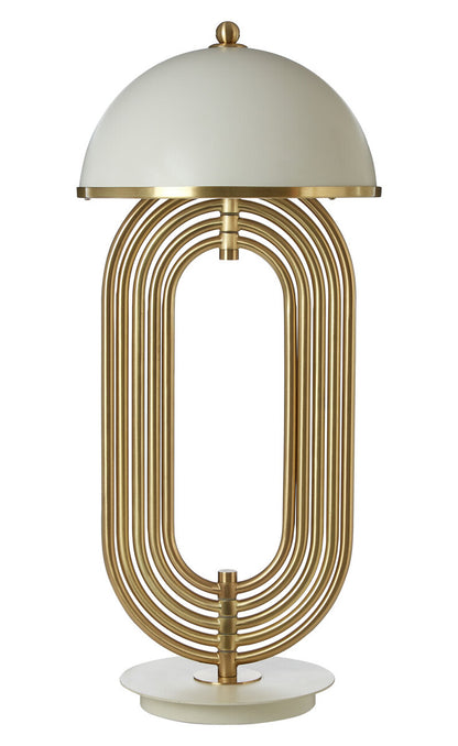 Decorative table lamp with gold metal base and white shade on a white background