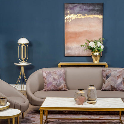 Modern living room with gray sofa, marble coffee table, and abstract art on blue wall.