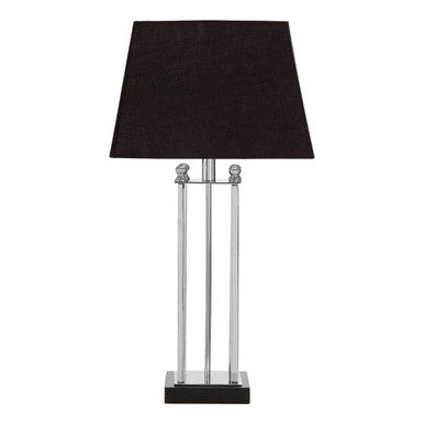 Table lamp with black shade and metallic base on a white background