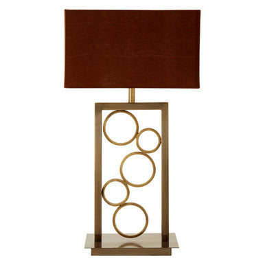 Table lamp with brown shade and gold circular design on a white background