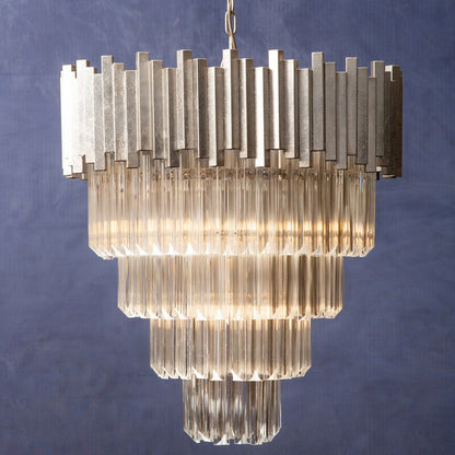 Chandelier with ribbed glass design against a textured blue wall