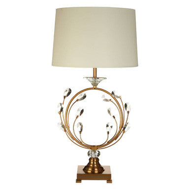 Decorative table lamp with gold base and leaf design on a white background