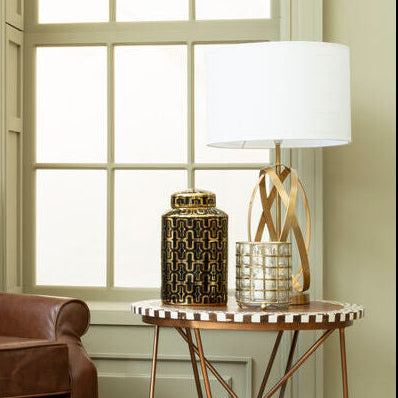 Brown leather armchair with a matching ottoman in a room with a large window.