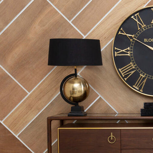 Wooden sideboard with decorative items against a tiled wall