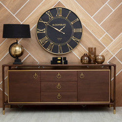 Wooden sideboard with decorative items against a tiled wall