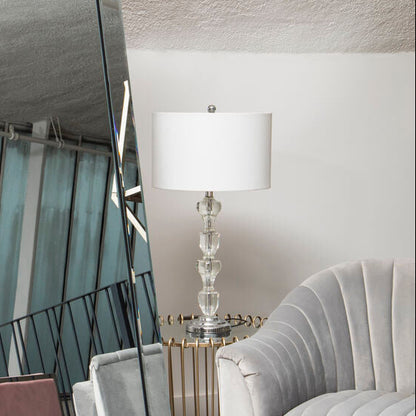 Tall floor mirror with geometric design in a room with a chair and lamp.