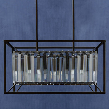 Modern pendant light with rectangular glass shade against a blue background