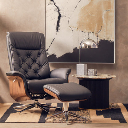 Leather armchair with ottoman in a room with abstract art on the wall.