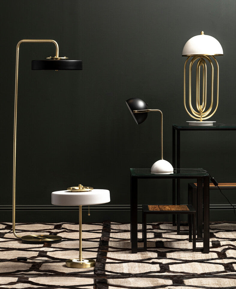 Modern interior with various lamps and a dark wall.