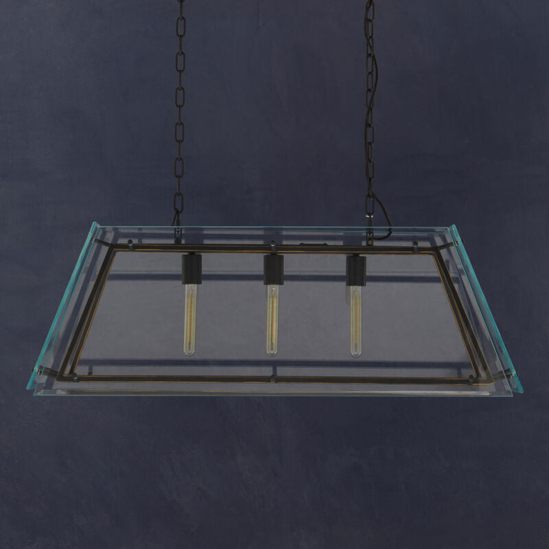Glass light fixture hanging from a chain against a dark background