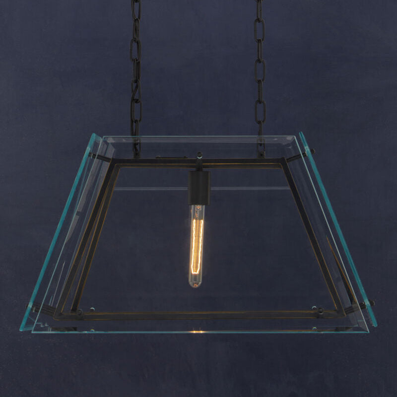 Modern pendant light with glass shade and metal chain against a dark background