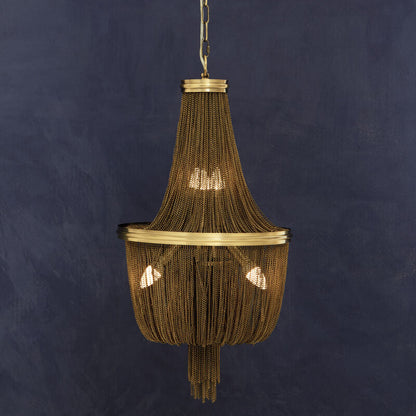 Decorative pendant light hanging against a dark blue wall