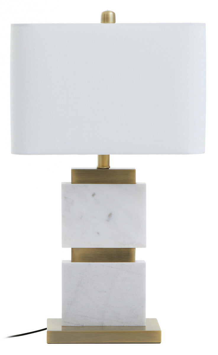 Table lamp with marble base and white shade on a white background