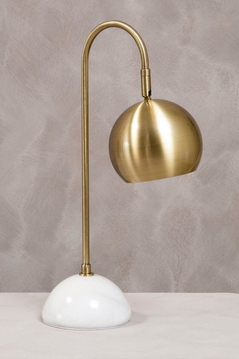 Gold desk lamp with white base on a gray background
