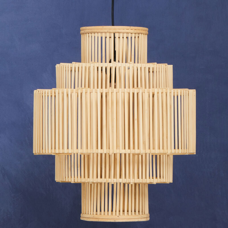 Woven rattan pendant light against a blue background