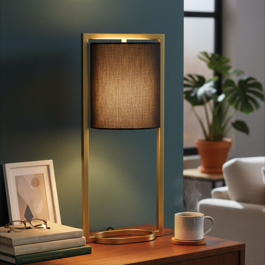 Table lamp on a wooden surface with a cup and books in a cozy room setting.