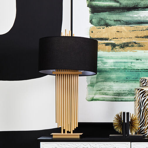 Modern console table with decorative items against a black and white abstract art background