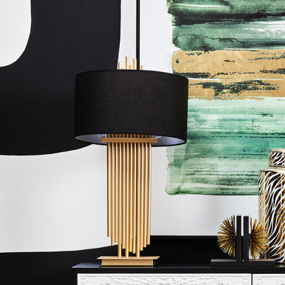 Modern console table with decorative items against a black and white abstract art background