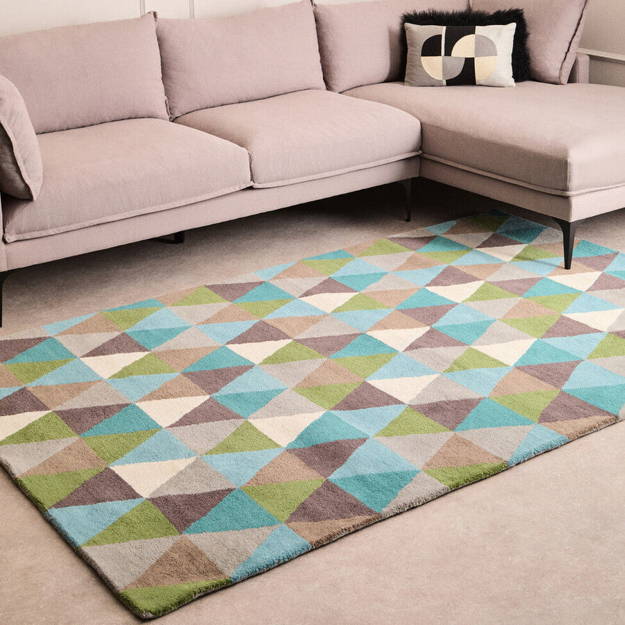 Sectional sofa with a geometric patterned rug in a living room setting