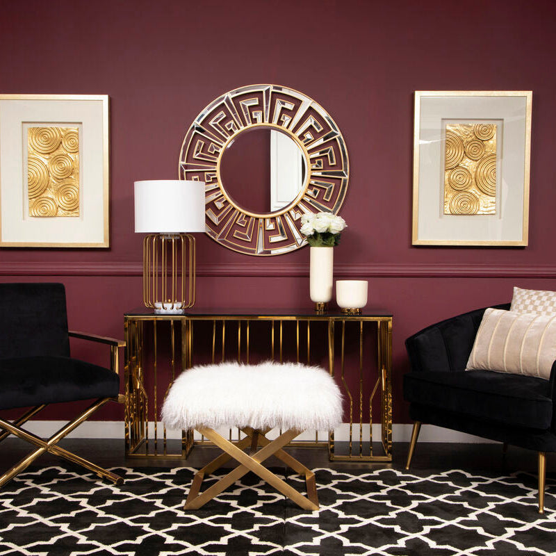 Modern living room with dark furniture, gold accents, and decorative wall art.