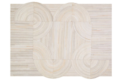 Beige woven rug with circular patterns on a white background