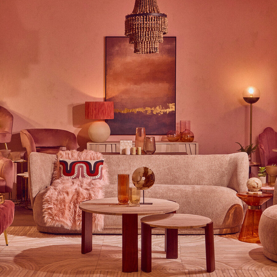 Luxurious living room with a chandelier, sofa, and decorative items.