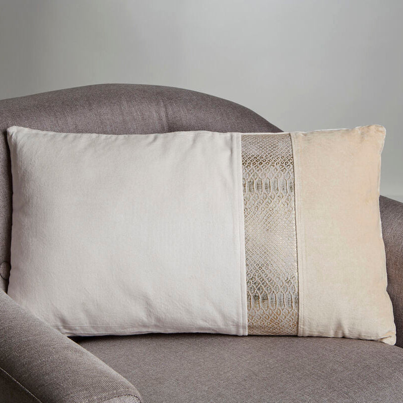 Decorative pillow with a geometric pattern on a gray armchair against a neutral background