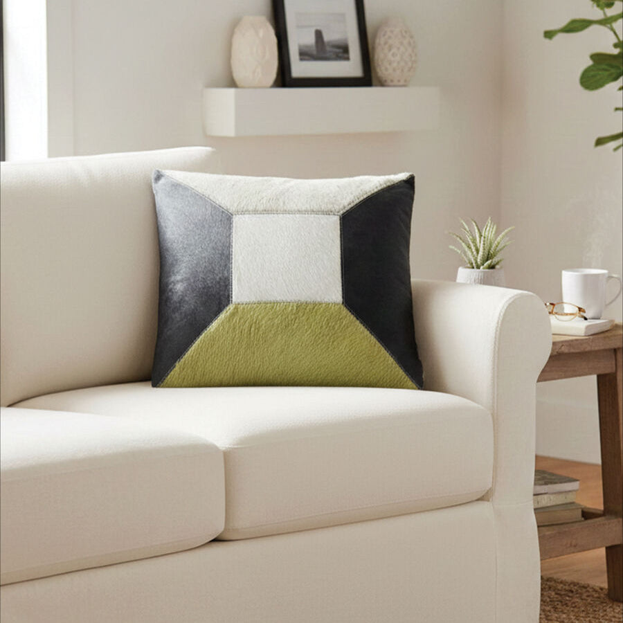 Beige sofa with a geometric-patterned pillow in a living room setting.