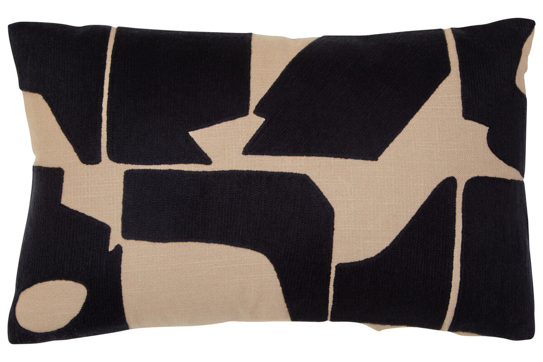 Decorative pillow with black and beige abstract pattern on a white background