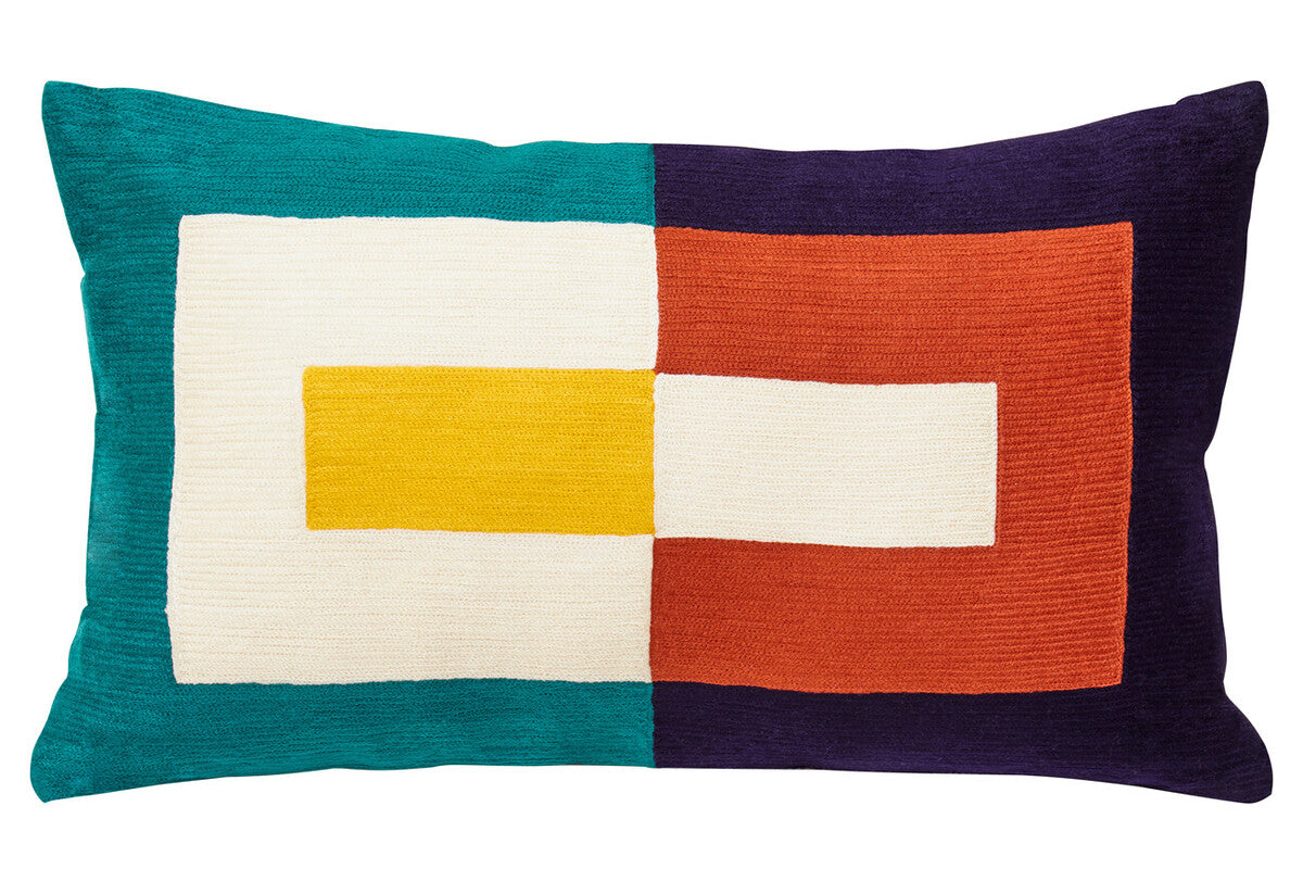 Colorful geometric pillow with a patchwork design on a white background