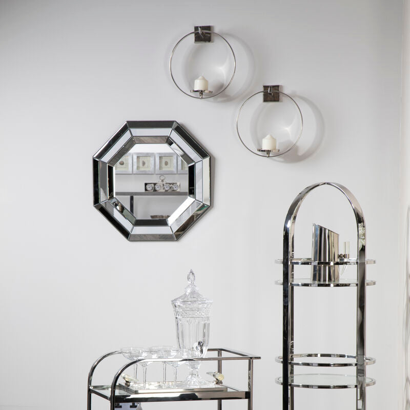 Modern bar cart and decorative shelves against a white wall.