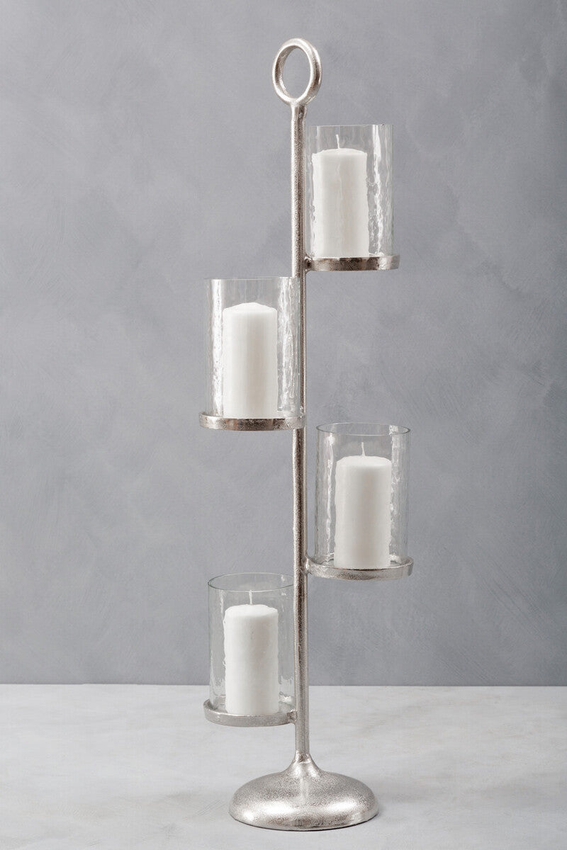 Silver candle holder with four glass candle holders on a gray background
