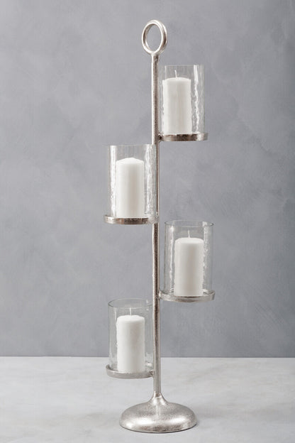 Silver candle holder with four glass candle holders on a gray background