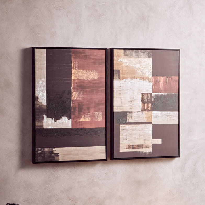 Two abstract framed artworks on a wall above a brown leather bench.