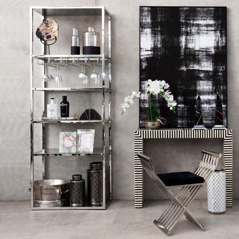 Modern interior with metallic shelving units and a console table.