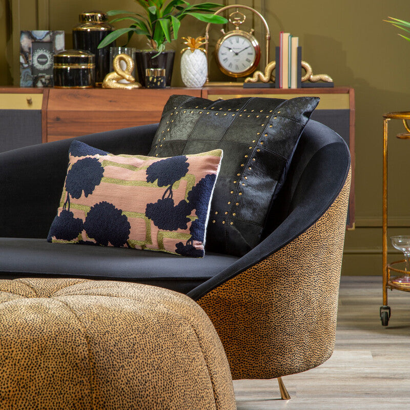 Decorative living room with a brown armchair, ottoman, and decorative items.