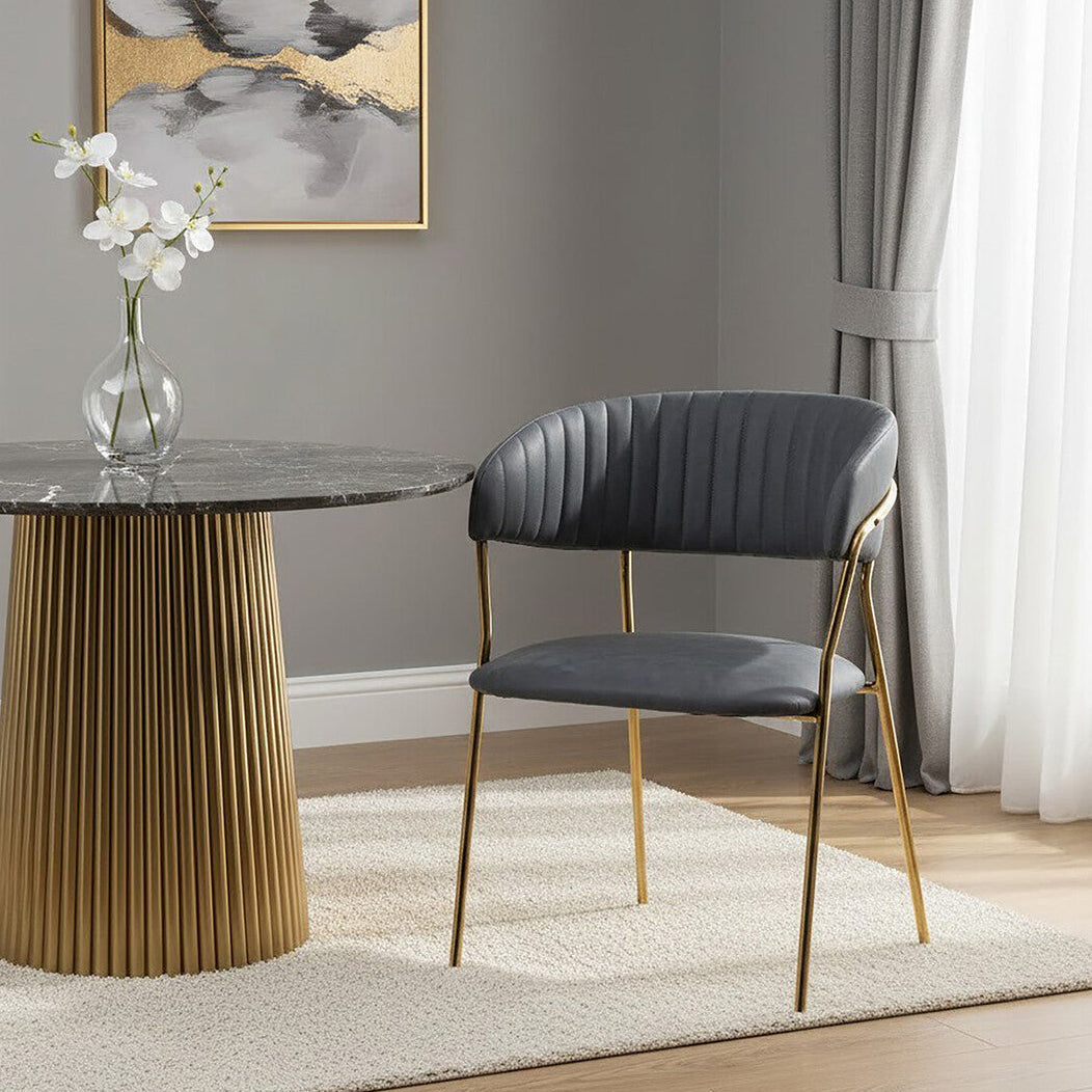 Modern dining room with a marble table and black chair against a gray wall.