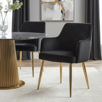 Dining room with black chairs, gold legs, and a abstract painting on the wall.