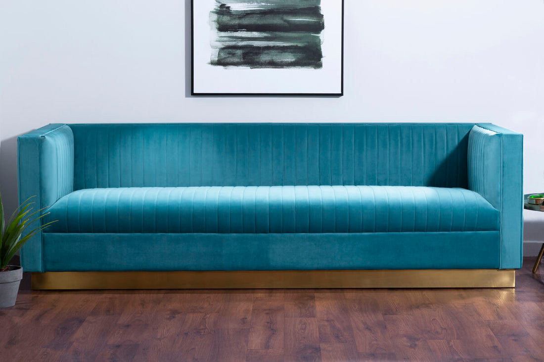 Blue sofa in a room with a abstract painting on the wall