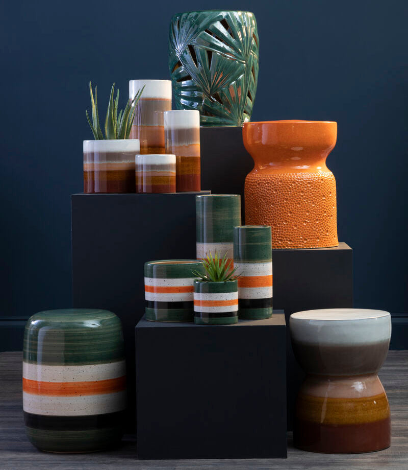 Collection of ceramic vases and planters on a dark background