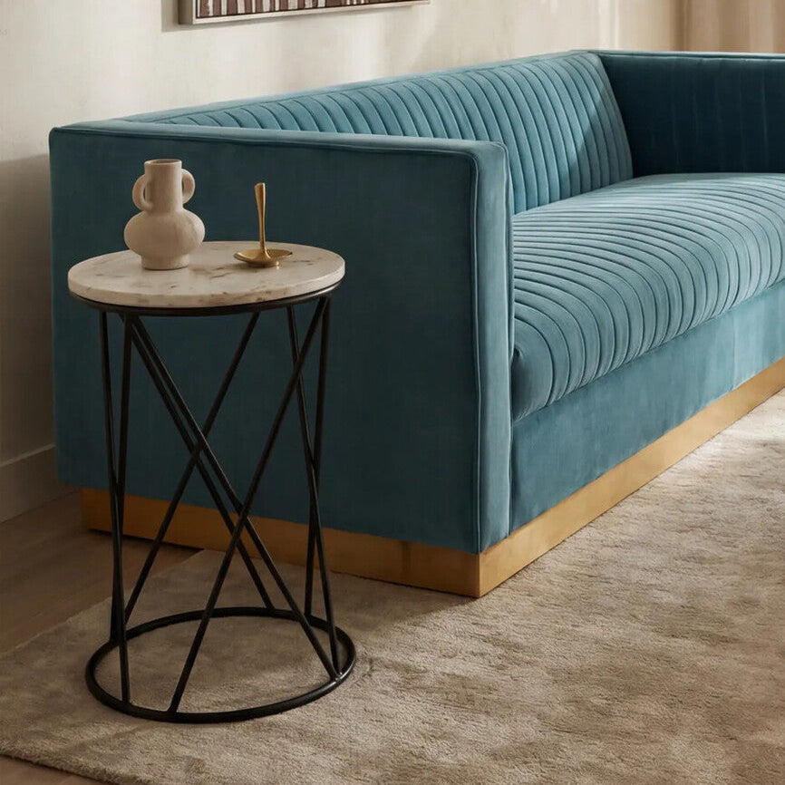 Blue sofa in a living room with a side table and decorative items.